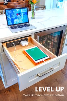 an open laptop computer sitting on top of a drawer