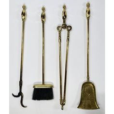 three brass - plated items including a broom, two shovels and a brush