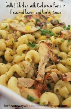 a white dish filled with pasta and chicken