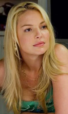 a woman with long blonde hair sitting at a table