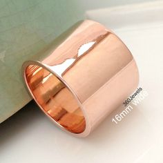 "The extra bold rose gold ring. Made from 925 sterling silver and plated in a very thick layer of 18K rose gold (2 micron plating). Stylish and simple. SPECIFICATION Approximate Ring Width: Approx 15mm-16 mm (just over 5/8\") Base metal: Silver Plating: 2 micron of 18K Rose Gold, Shiny polished finish Ring size: USA size 3 to 14. Whole, half, quarter, and international sizes can be made. Price will vary for sizes above 12. Custom size: Select this ring size option If you do not see your size in Chunky Wedding Band, Rose Gold Wedding Band, Ring Rosegold, Rose Gold Wedding Bands, Wide Ring, Thumb Ring, Wide Rings, Wide Band Rings, Thumb Rings