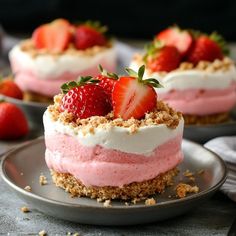 two small desserts with strawberries on top