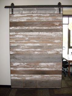 the sliding door is made out of wood and has metal bars on each side,