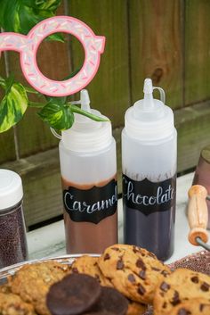 chocolate chip cookies and milk bottles on a table