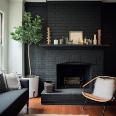 a living room filled with furniture and a fire place in front of a brick fireplace