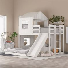 a white bunk bed with a slide next to it in a room filled with furniture