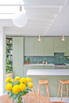 the kitchen is clean and ready for us to use in its new home, as well as flowers on the dining room table