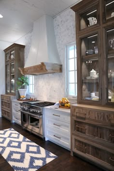 a kitchen with wooden cabinets and white walls