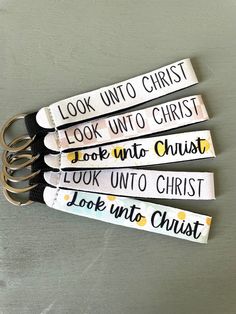 four pairs of scissors with the words look unto christ printed on them, sitting next to each other