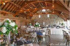 the inside of a wedding venue with tables and chairs set up for guests to eat