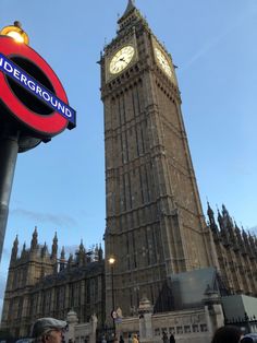 the big ben clock tower towering over the city of london, england with people walking around