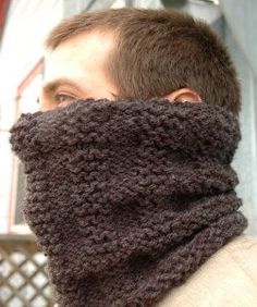 a man wearing a knitted neckwarf in brown and grey colors, with his eyes closed