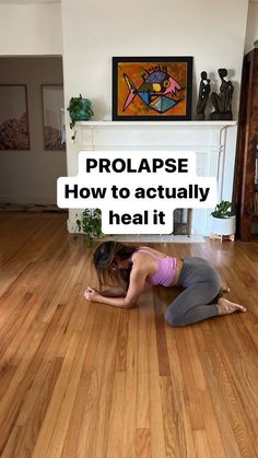 a woman is doing yoga on the floor in front of a fireplace with text overlay that reads, prolapse how to actually heal it