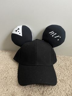 These amazing matching hats for newlyweds will make a honeymoon trip even more special! It has a black fabric and white tulle with custom iron on designs and a silver sequin fabric bow, accented with Happily Ever After ribbon!  Each pair is made to order! Can be any character, color, or theme! DM me if you would like a pair! Iron On Designs, Disney Honeymoon, Honeymoon Trip, Matching Hats, Sequin Bow, White Tulle, Ear Hats, Fabric Bows, Mickey Ears