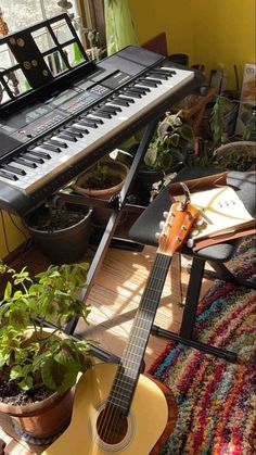 an electric guitar sitting on top of a wooden floor next to a potted plant