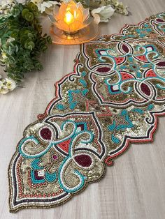 three decorative placemats sitting on a table next to flowers