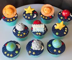 cupcakes decorated with space themed icing on a plate