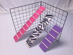 three pieces of pink, purple and zebra print tie sitting on top of each other