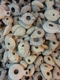 a pile of clay pots with holes in them