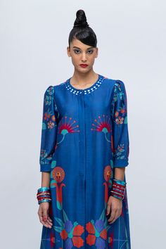 Midnight blue straight kurta with floral print and delicate mirror embroidery. Paired with a pant with patterned patch.
Components: 2
Pattern: Printed, Embroidered
Type Of Work: Floral, Mirror
Neckline: Round
Sleeve Type: Puffed
Fabric: Cotton Silk Blend
Color: Blue
Other Details: 
Approx. product weight: 800 gms
Model Height: 5ft 9inches, wearing size S
Note: Jewellery worn by the model is not for sale.
Occasion: Puja - Aza Fashions Blue Ikat Print Top For Summer, Bohemian Blue Blouse With Printed Motifs, Blue Bohemian Blouse With Printed Motifs, Fitted Blue Tops With Printed Motifs, Summer Indigo Sets With Printed Motifs, Bohemian Blue Set With Floral Embroidery, Bohemian Blue Sets With Floral Embroidery, Festive Blue Floral Print Sets, Festive Blue Blouse With Floral Print