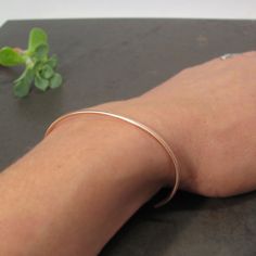 "Timeless skinny 14k gold cuff with a hammered or a smooth texture, you choose! I hand shaped the cuff out of 2mm round wire. I gave the cuff a hammered texture and balled the ends with my torch. The cuff is not hollow, it is solid gold all the way through. Can also be worn upside down with the opening on the top of your wrist for a modern look. Simple and elegant, the perfect skinny cuff for every day wear! Cuff is 5.5\"L and has an opening of approximately 1\". It fits medium to small wrists a Minimalist Everyday Rose Gold Cuff Bracelet, Hammered Rose Gold Cuff Bracelet Gift, Minimalist Rose Gold Bangle With Polished Finish, Minimalist Hammered Cuff Bracelet As Gift, Minimalist Hammered Cuff Bracelet Gift, Gold Cuff Bracelet, Sweet Ring, Gold Bracelet Cuff, Gold Cuffs