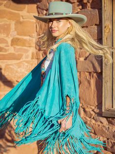 Long and luxurious, the Rio Grande Shawl is a western classic by American designer, Tasha Polizzi. Made from super soft goat suede in rich saturated colors with 14" hand-tied fringe along thee hem. The shawl is best worn open, draped over the shoulders of a western shirt or a plain tee with a statement necklace for a more modern style. AQUA is back for a limited time. These sell out fast so grab one quick! Only Available in AQUA at the Moment!