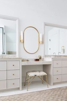 a white bathroom with two sinks and a mirror on the wall next to a stool