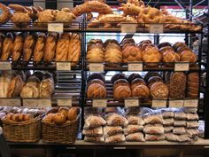 breads and pastries on display in a bakery