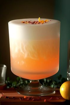 an orange and white drink sitting on top of a table