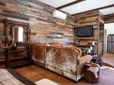 a living room with wooden walls and furniture