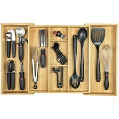 an assortment of kitchen utensils in a wooden box