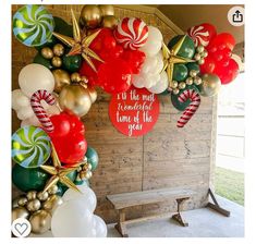 the balloon arch is decorated with red, white and green candy canes on it