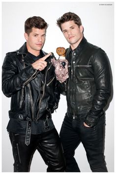 two men in black leather jackets are posing for the camera with one holding a cookie