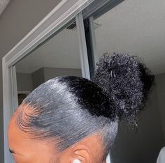 a close up of a person with hair in a bun