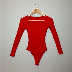 a red bodysuit hanging on a hanger