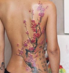 the back of a woman's body with flowers painted on her back and chest