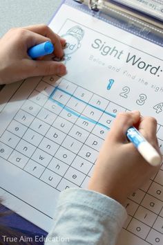 a child is writing on a sight word puzzle