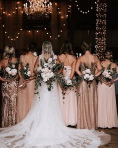 a bride and her bridal party posing for a photo