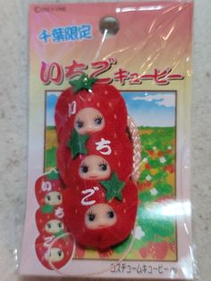 a package with three dolls in the shape of tomatoes