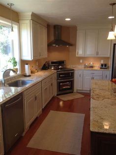 a kitchen with an oven, dishwasher, sink and refrigerator is shown in this image