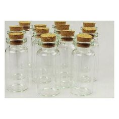 six clear glass bottles with cork lids