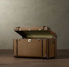 an open suitcase sitting on top of a wooden floor