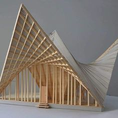 a wooden structure that has been constructed to look like a boat with sails on it