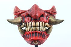 a red demon mask with horns and fangs