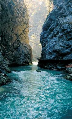 a river flowing through a canyon surrounded by rocks