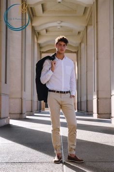 a young man is standing in an archway