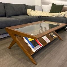 a coffee table with books on it in front of a couch