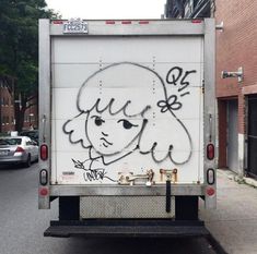 the back of a truck with graffiti on it