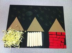 an art project made out of construction paper and sticks