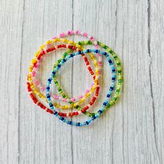 "Colorful, dainty seed bead bracelet stack are the perfect accessories to any outfit!  📌 This listing is for 1 colorful seed beads boho bracelets 📌 Each bracelet is beautiful unique in its own way. We cannot guarantee they will look exact same as pictured 📌 CUSTOM BRACELET: If size other an 6.5\" is needed, please include the size needed!! 📌 These multi colorful confetti bracelets are double knotted and glued shut  📌 Each order is packing in a small drawstring bag ready to be given as a gift! 📌All order will be shipped within 1-2 business days of purchase  📌All order are handing with great care and checked thoroughly before it is shipped to you  📌 Caring Tips:  *Roll the bracelets up your hand to your writs. *I recommend keeping your bracelets dry and away from water. Try to keep o Multicolor Tiny Beads Wrap Bracelet For Friendship, Friendship Beaded Chain Bracelets, Adjustable Beaded Friendship Bracelets, Multicolor Beaded Chain Friendship Bracelets As Gift, Multicolor Beaded Chain Friendship Bracelet For Gift, Multicolor Beaded Chain Friendship Bracelet, Colorful Beaded Chain Bracelets As Gift, Festival Friendship Bracelets With Beaded Chain, Festival Friendship Bracelets With Round Beaded Chain